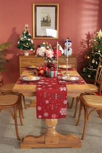 Detailed view of festive red table runner and placemats with Christmas ball patterns