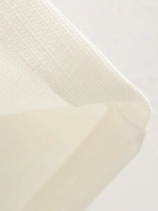 Detailed close-up showing the white knitted texture and stitching of the vest pants set