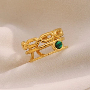 Close-up of 18K gold-plated multi-layer ring with natural green malachite on velvet