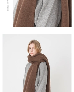 Detail of brown mohair scarf with thick texture and fringe worn with a grey knit sweater