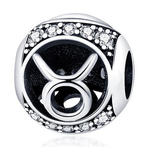 Macro shot of silver Taurus zodiac charm bead with white cubic zirconia inlay