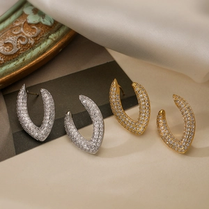 Irregular geometric U-shaped hoop earrings with micro-paved zircons in gold and silver