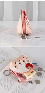 Detail of pink strawberry coin purse with heart cutout, PU leather and metal keychain