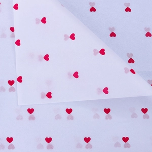 Translucent white wrapping paper featuring small red heart patterns and folded corner