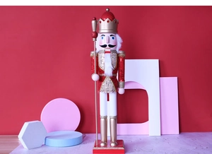 Close-up of a 62cm red and gold wooden nutcracker king with sequins and scepter