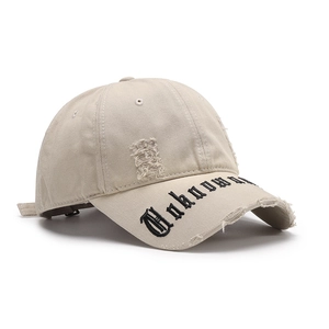 Distressed khaki baseball cap with vintage rips and gothic letter embroidery on the brim