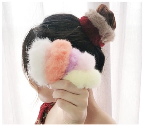 Detail of plush faux fur scrunchies in multiple colors for high ponytail hairstyles