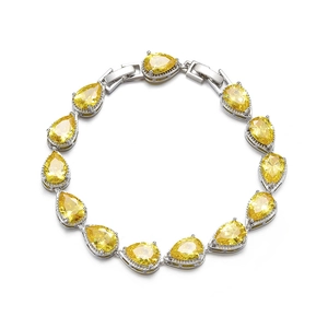 Detailed view of silver bracelet with sparkling pear-cut yellow cubic zirconia stones