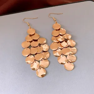 Elegant gold layered sequin drop earrings with polished discs and a vintage hook style