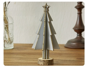 Detailed view of mini grey wooden Christmas tree with gold glitter and solid wood base