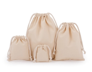 Four different sizes of beige canvas drawstring storage bags on a clean white background