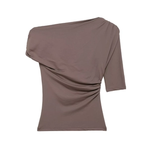 Close-up of taupe one-shoulder top showing ruched side details and stretch fabric texture