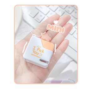 Mini portable square stapler with orange accents shown held in hand for scale
