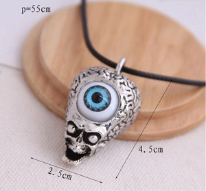 Detailed view of skull pendant with blue eye charm including dimensions 4.5x2.5cm and chain