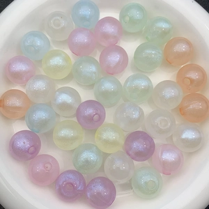 Luminous macaron color resin loose beads with iridescent finish in a white dish