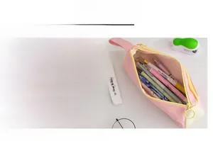 Detail of pink and beige pencil case showing smooth metal zipper pull and handle