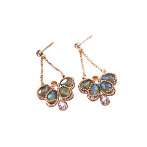 Elegant butterfly earrings with blue crystals and pink waterdrop pendants on white background