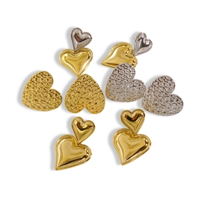Classic 14K gold and silver heart studs with polished and hammered metal textures