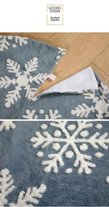 Detail view of snowflake pattern plush Christmas tree skirt with velcro fastener