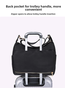 Detail showing the trolley sleeve and bottom zipper for securing the black nylon tote bag