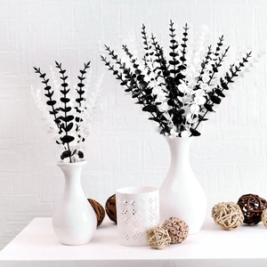 Minimalist black and white eucalyptus artificial flowers in white vases for home decoration