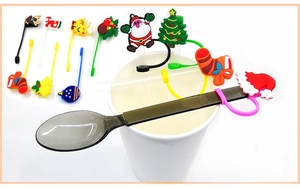 Detailed close-up of colorful silicone Christmas straw covers on a spoon and white cup