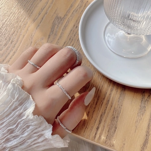 Sparkling silver 925 stackable rings with fine crystals shown on a wooden background