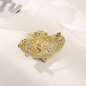 French style gold hat brooch with textured hammer pattern and secure safety pin