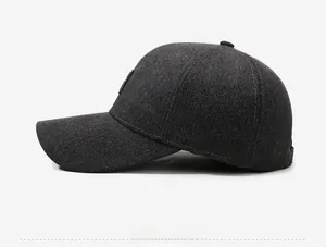 Side view of dark grey winter baseball cap with white Down the street embroidery