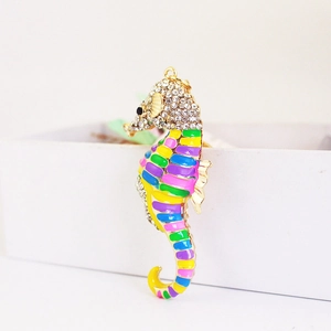 Sparkling seahorse keychain with colorful enamel and rhinestones on a white box