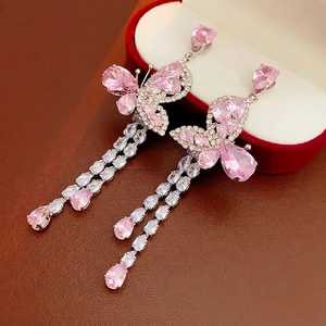 Pink butterfly zircon tassel earrings with silver needle on luxury jewelry box display