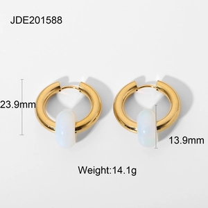 Detail view of gold earrings with cream stone pendants including size and weight specs
