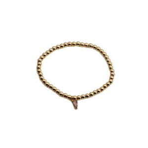 Detail of gold beaded bracelet featuring a V-shaped pendant with colorful gemstones