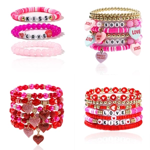 Detail of pink and red beaded bracelets with letters XOXO and KISS in a set