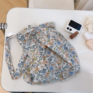 Floral cotton shoulder bag with blue and orange prints on a white background