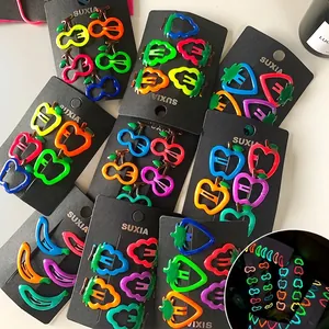 Glow-in-the-dark fruit hair clips for kids in neon colors on a display card