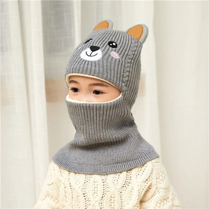 Detailed knit texture of grey hooded deer hat with cute ears and cartoon embroidery