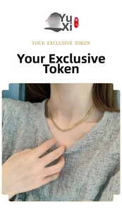 Close-up of double-row flat gold snake chain necklace showing vintage metallic texture