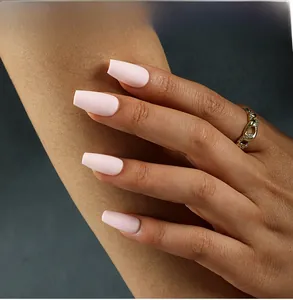 Detailed macro view of matte light pink ballerina style press-on nails with fine finish