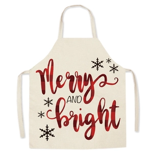 Detail of linen Christmas apron with red black plaid text Merry and Bright and snowflakes