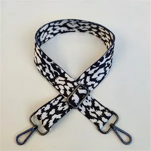 Detail of leopard print bag strap with adjustable gunmetal buckle and lobster clasp