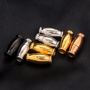 Macro shot of 8 stainless steel magnetic jewelry clasps in four finishes on dark fabric