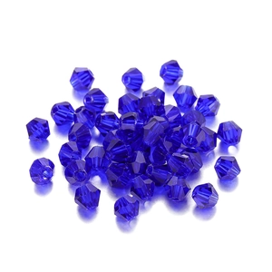 Close-up of faceted deep blue bicone crystal glass beads for DIY jewelry making