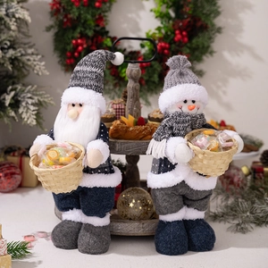 Detail of Christmas Santa and Snowman plush dolls holding small bamboo candy baskets