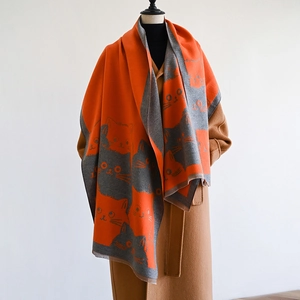 Detail of cute cat pattern on thick orange and grey reversible cashmere feel shawl