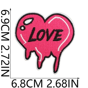 Macro detail of magenta heart-shaped love embroidery patch with size dimensions