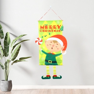 Detail of Christmas wall banner with cartoon elf and Merry Christmas text on white wall