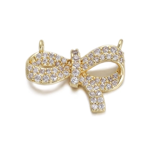 Detailed close-up of a gold butterfly pendant featuring pavé-set shimmering cubic zirconia
