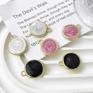 Golden round enamel disc pendants in white, pink, and black for DIY jewelry making