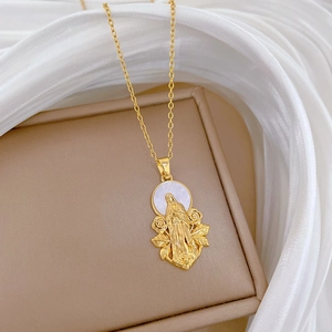 Macro detail of a gold titanium necklace with a shell cameo and floral crystal borders